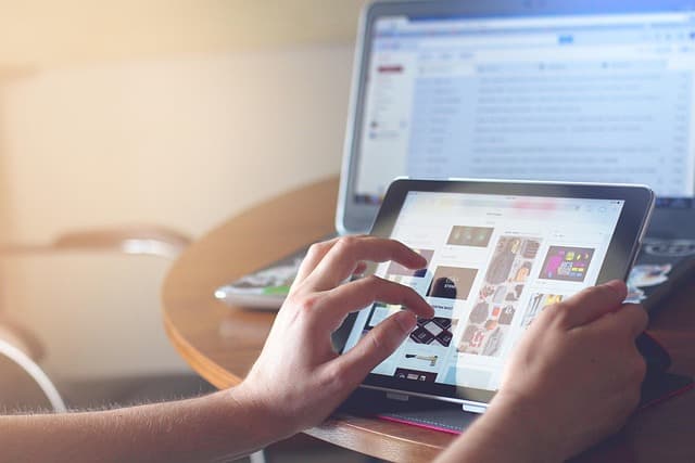 Marketer reviewing an app store listing and download analytics on a smartphone while planning app store optimization