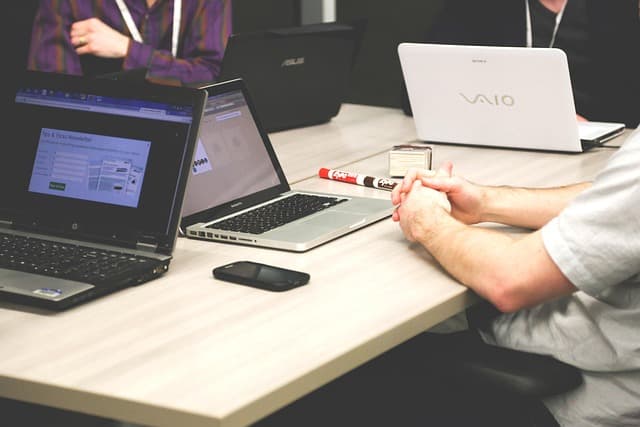 A small business team reviewing an automated workflow dashboard on a screen while planning process improvements