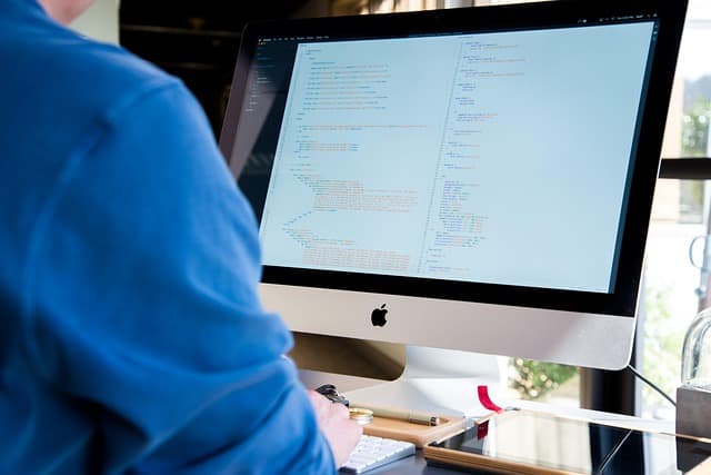 Security analysts monitoring alerts on screens while coordinating a cyber security incident response
