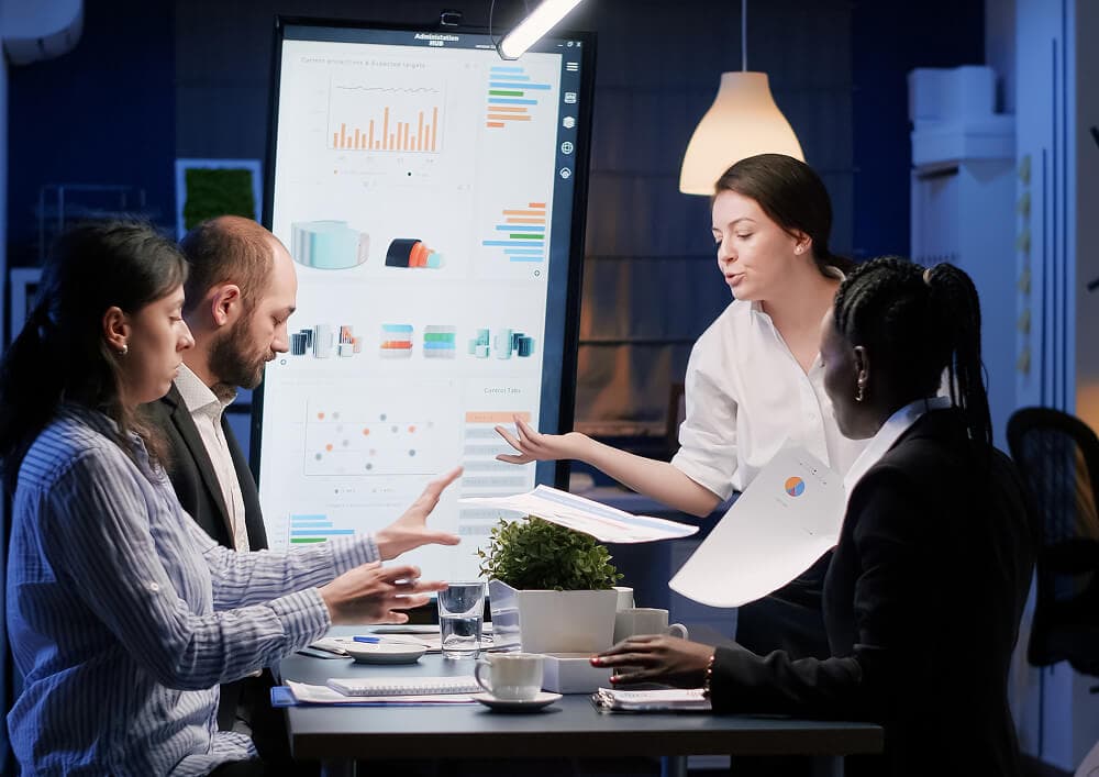 A software engineer sketching a system architecture diagram on a whiteboard during a planning session