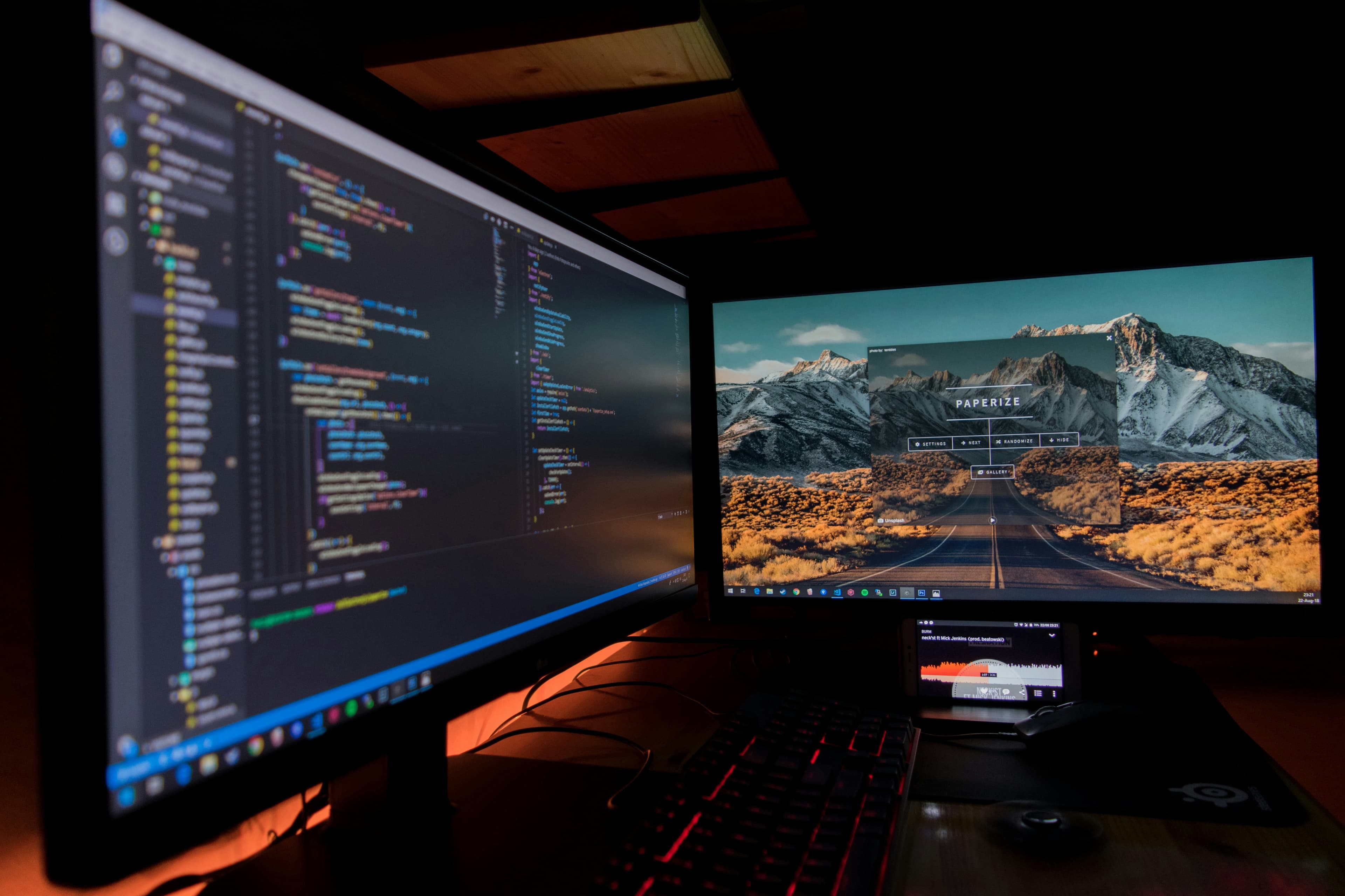 Mobile developer profiling app performance on a phone and laptop, reviewing frame rate and startup metrics