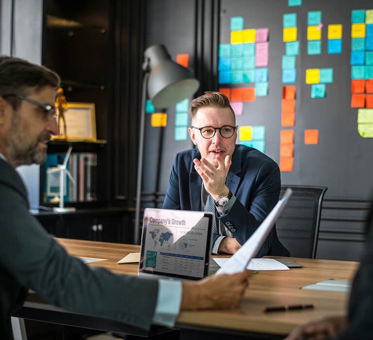 Analyst reviewing a business intelligence dashboard of charts and KPIs on a widescreen monitor