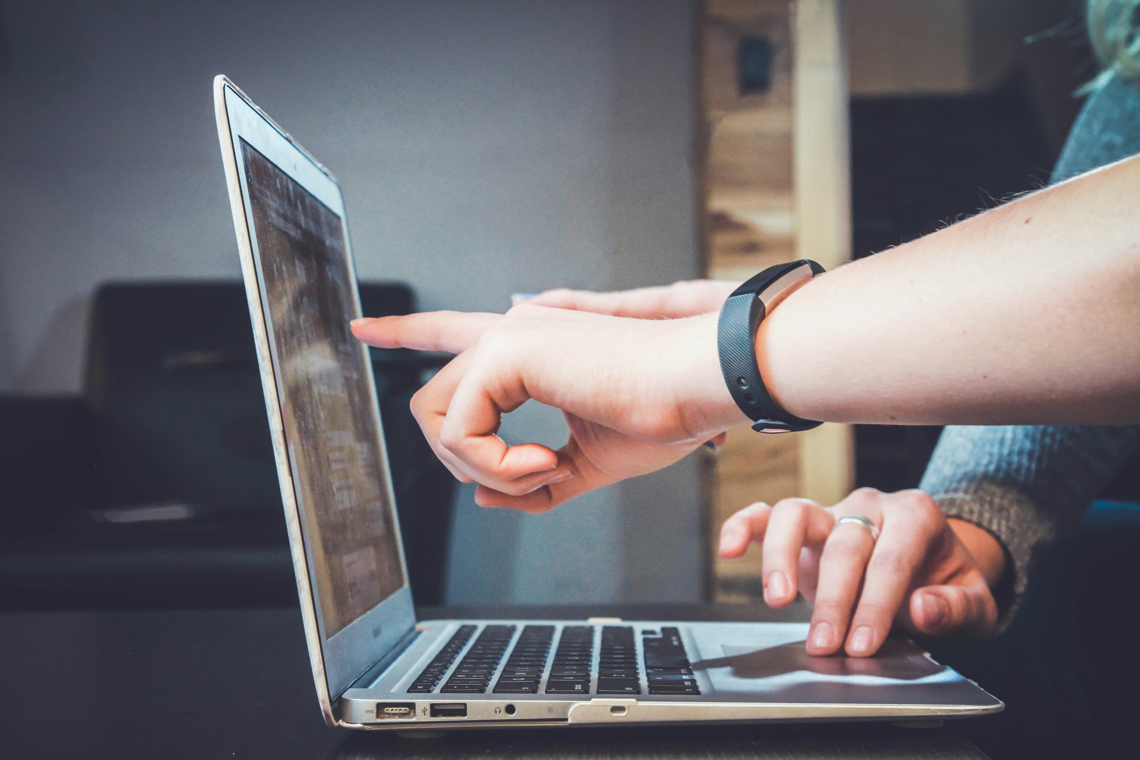 A person using a screen reader and keyboard to navigate an accessible website on a laptop